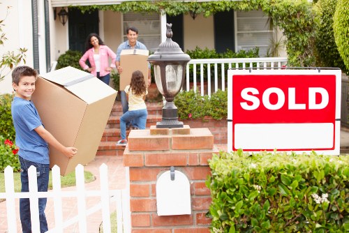 Van moving service handling boxes and household items near Belsize Park